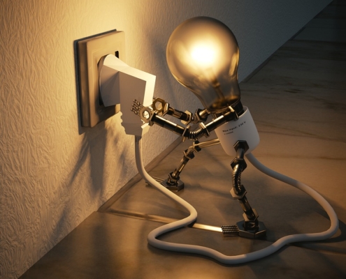 A cartoonized light bulb is pulling itself out of the socket to demonstrate the problems with energy usage and efficiency.
